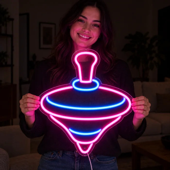 Spinning Top Neon LED Sign held by a smiling woman against a dark background