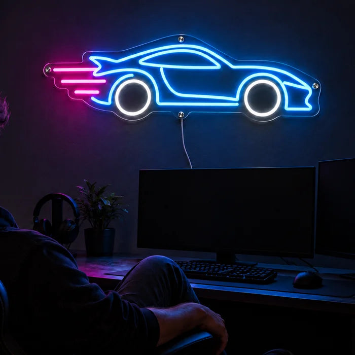 Speed Roadster Neon LED Sign above a gaming desk, a gamer in a gaming chair in front of it