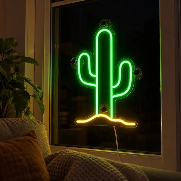 Desert Cactus Neon LED Sign in the window of a cosy living room in the evening