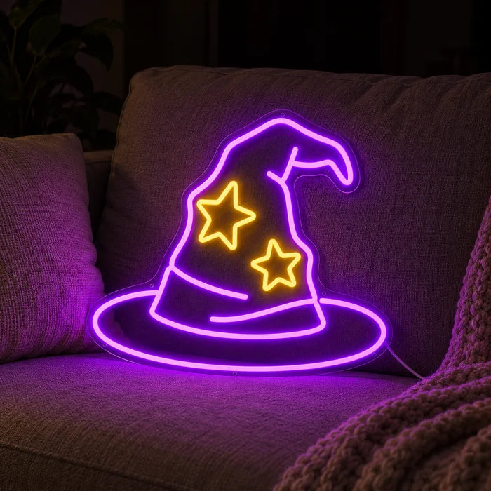 Wizard Hat Neon LED Sign on a cosy sofa between cushions and a throw
